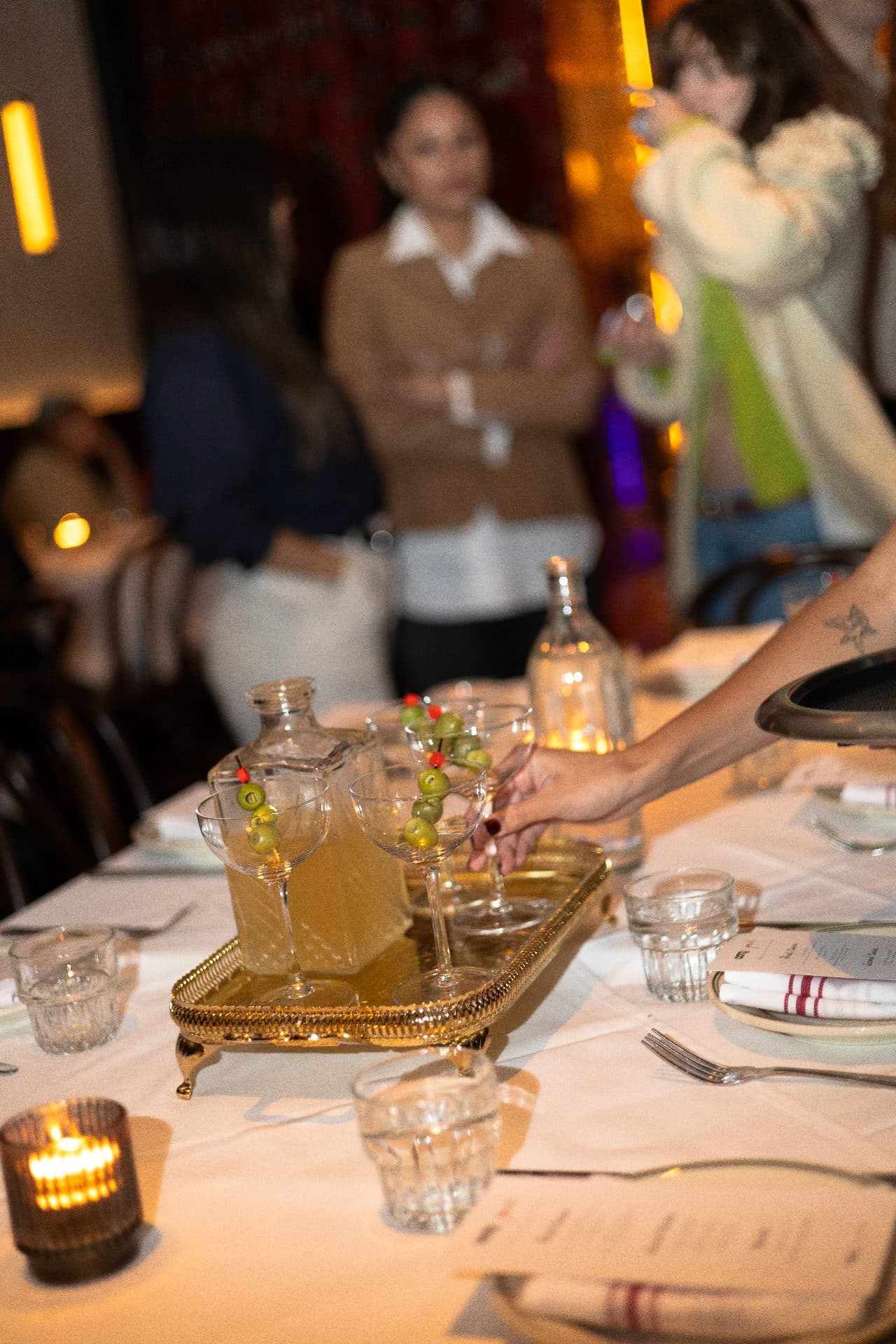 Martinis on a gold tray at a brand dinner